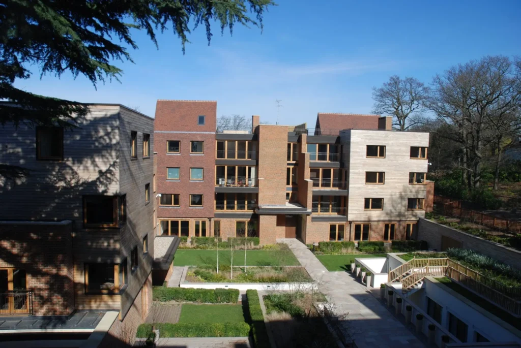 Modern apartment development on The Bishop’s Avenue featuring timber windows and doors by Gowercroft Joinery, set around landscaped communal gardens with a mix of brick and timber cladding.