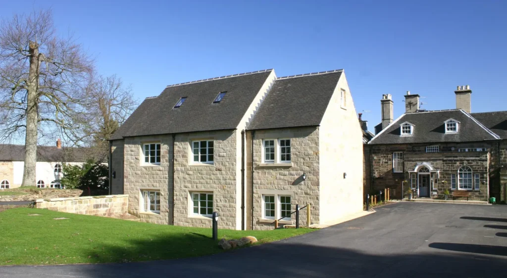 View of Holbrook Hall in Derbyshire, a Grade II listed building featuring traditional-style timber windows with slim double glazed units in Accoya, blending modern performance with heritage aesthetics.