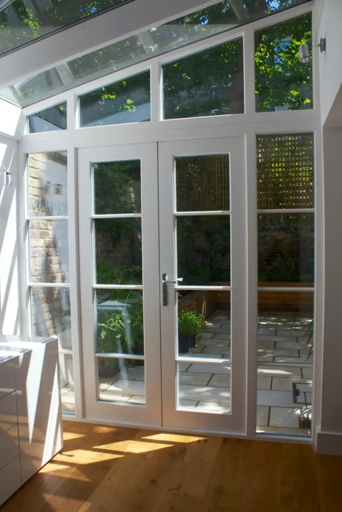 Internal view lean to conservatory angled screen french doors white