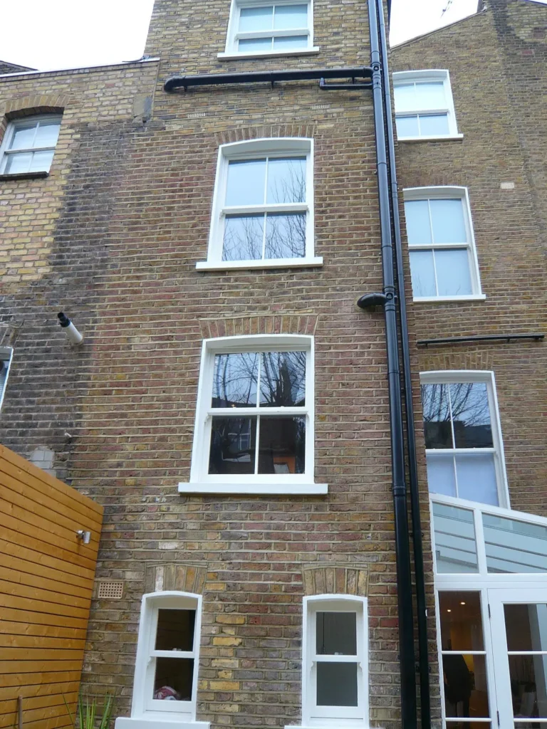 White Chatsworth sliding sash windows lean to conservatory townhouse