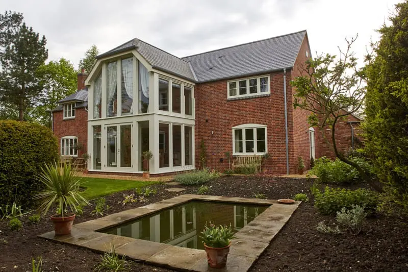 Hardwick casement window white painted red brick elevation horizontal bar new build glazed 2 two storey screen clad steel 2
