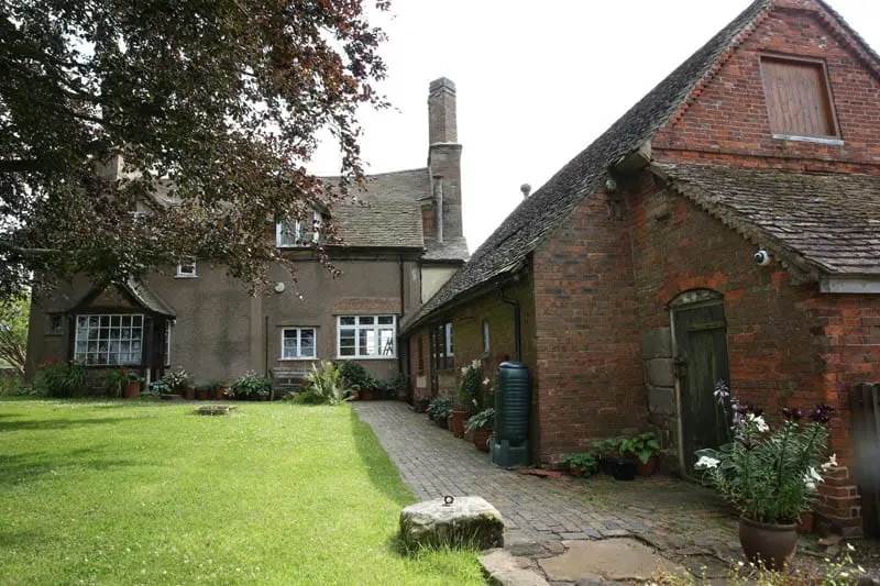 Rear view of colliers oak farm showing the barn and farm house with new casement windows