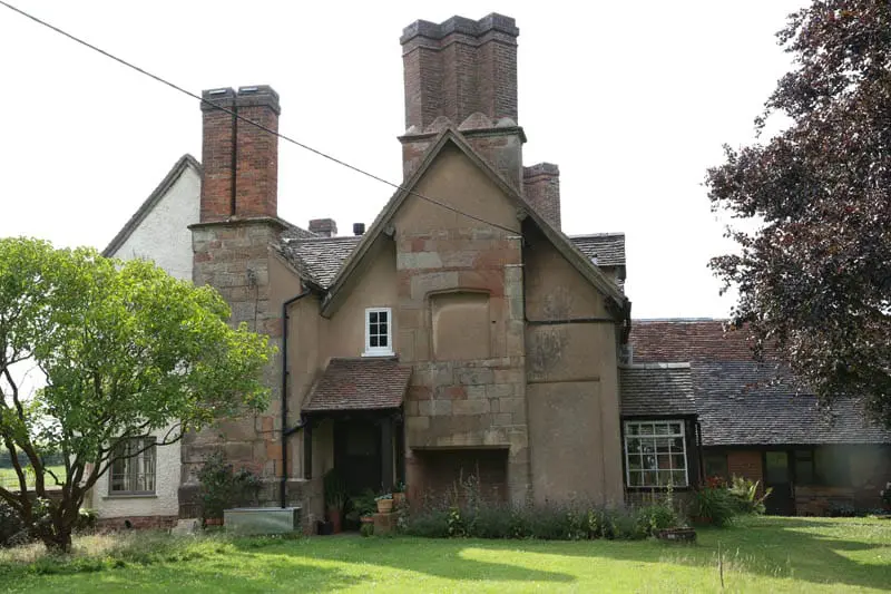 Wide shot of the side of Colliers Oak Farm showing the older farm building after new heritage casement windows have been fitted