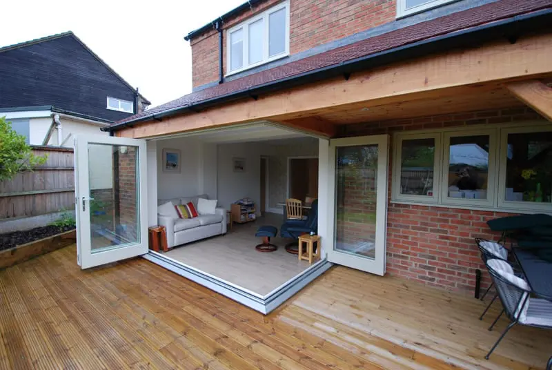 Fully opened floating corner bifold door opens up living room to garden.