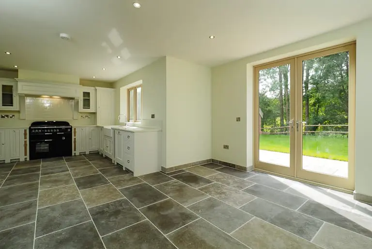 Interior of Melbourne Arms restoration development with traditional doors leading from stone flag floor to patio