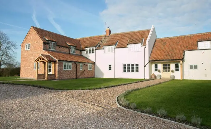
White Cottage replacement windows main image showing hardwick timber casement windows and the extension to the property