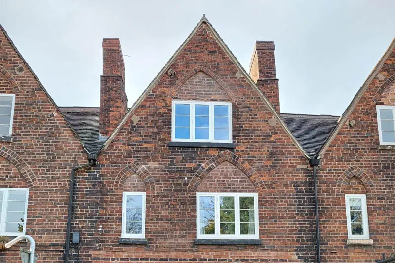 Front view of The William White Buildings in Staffordshire, showing restored heritage-style timber casement windows by Gowercroft Joinery set within decorative Victorian brickwork.