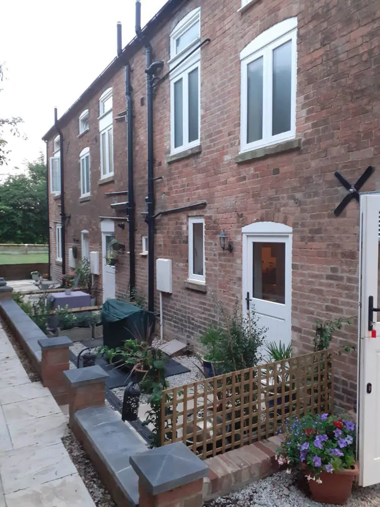 Canal Side Cottages: angled shot of the front elevation showing melbourne doors and casement windows