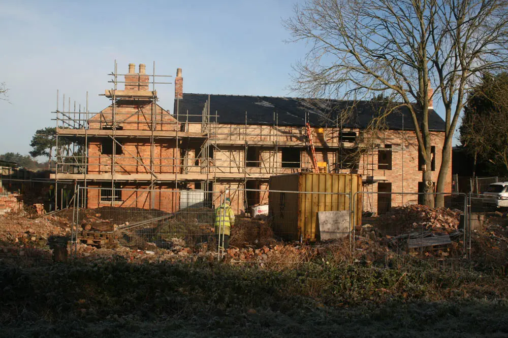 Canal Side Cottages: long shot of the cottages in a state of disrepair during restoration