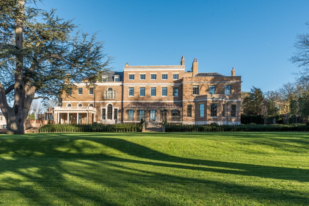 Exterior view of Templeton House, a historic brick mansion with large windows, including Gowercroft's Winston sliding sash windows, seamlessly blending traditional aesthetics with modern performance.
