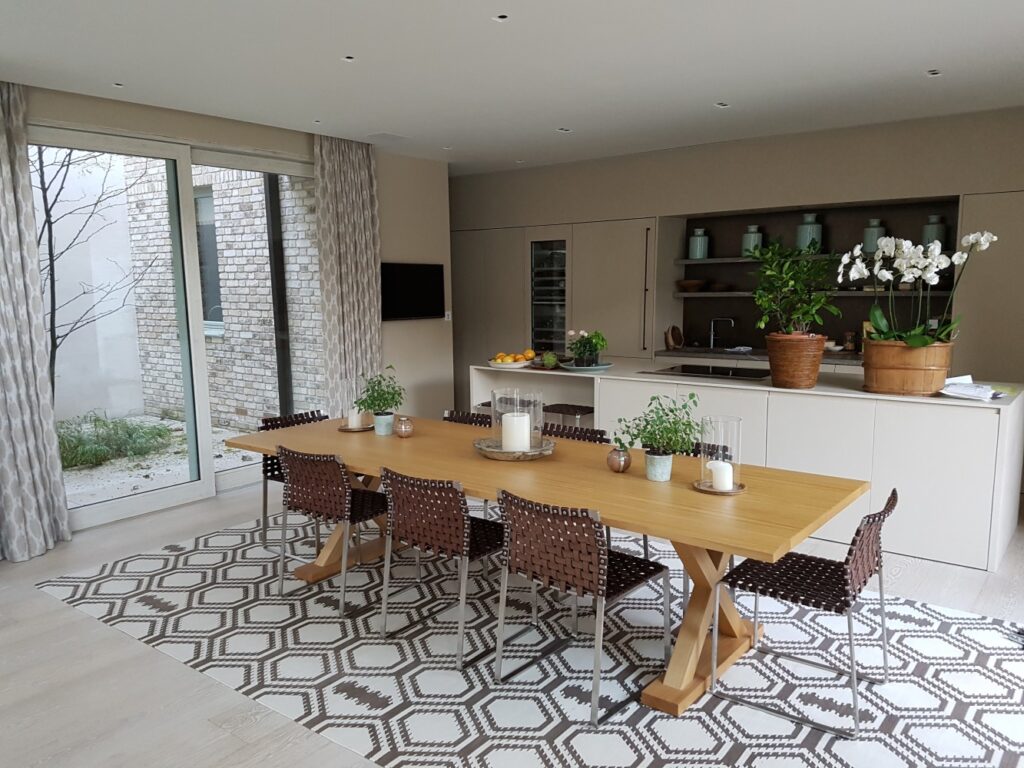 A Peveril Lift and Slide Door seamlessly connects this modern kitchen-dining space to a private courtyard. The expansive glazed panels maximise natural light, while the slim timber frame enhances the clean, contemporary aesthetic. Designed for effortless operation, the lift-and-slide mechanism allows for smooth, weightless movement, making it easy to open up the home to fresh air and outdoor living. Perfect for low-energy homes and modern extensions, combining style, performance, and uninterrupted views.