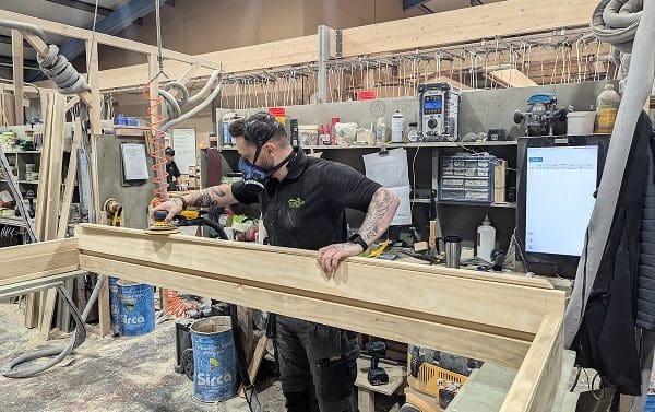 Gowercroft Joinery employee sanding a door frame